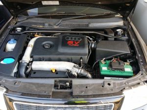 Picture of a cars engine with the bonnet open.